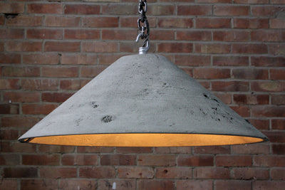 Our Lustrous Natural 2 raw surface artisan concrete pendant light showing chain hook and concrete surface detail,  the counter balance lead weight, chain and electrical cable. Also showing the ROC embossed logo on the concrete lampshade, the inside surface detail bulb and counter balance weight