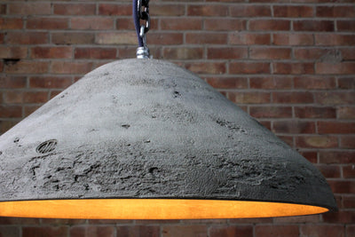 Our Gleam Natural 2 raw artisan concrete pendant light showing chain hook and concrete surface detail
